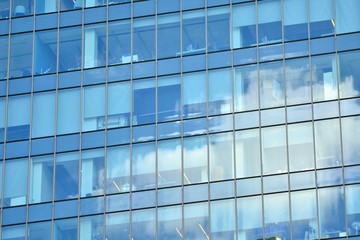 Naklejka na ściany i meble Modern office building wall made of steel and glass with blue sky