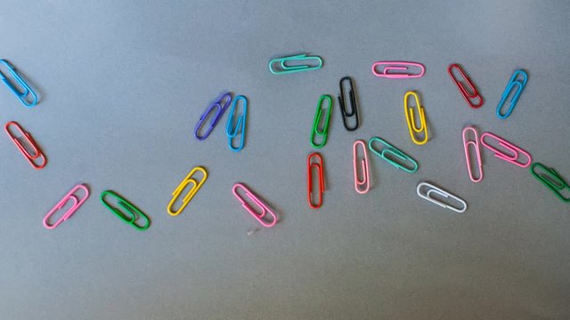 Word 'work' made of colorful paper clips. Animation.