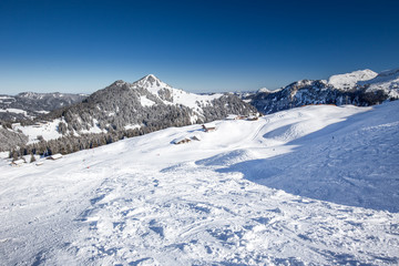 Fototapeta na wymiar Beautiful winter landscape. People skiing in Hoch Ybrig ski resort, Switzerland, Europe.
