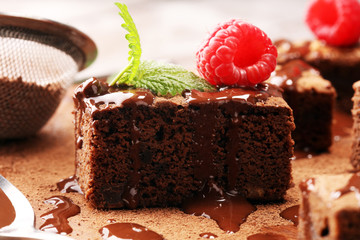 chocolate brownie cake dessert with raspberry and spices on a rustic background