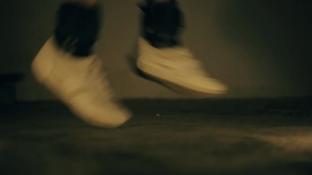 Legs wearing black colored ankle weights and doing various jumping and running exercises. 