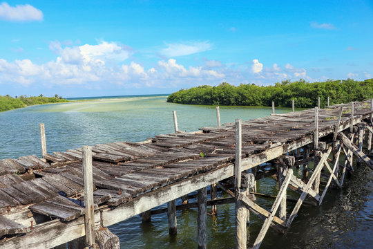 Old tropical destroyed wooden bridge in Sian Kaan Tulum Mexico. Mayan riviera summertime. - Image