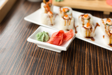 the ginger and wasabi on the plates. sauces to sushi