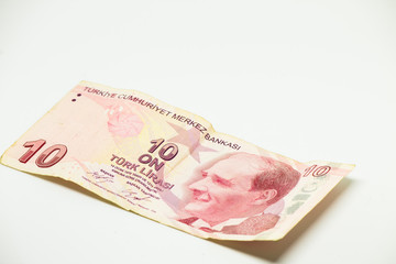 Coin and paper money turkish liras on white and wood background