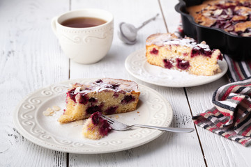 Fototapeta na wymiar Breakfast concept, Homemade slice of shortbread dough raspberry pie with almond petals