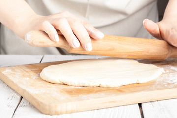 hands making dough on kitchen, close up view