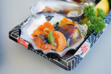 Dish of oysters stuffed with black and orange caviar