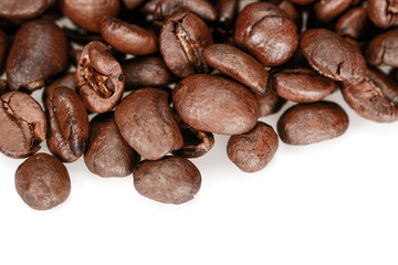 Dark brown roasted coffee beans, macro close up, isolated on a white background