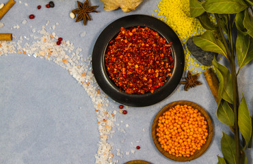 spices in bowls on blue background