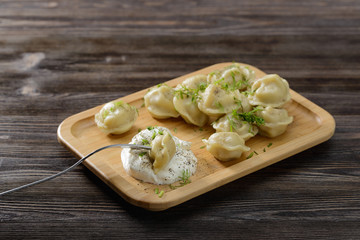 dumplings with sour cream, greens and pepper