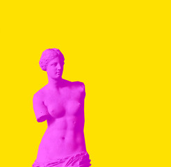  The Venus de Milo is an ancient Greek statue created between 130 and 100 BC. Creative magazine style concept of red neon Aphrodite woman on yellow background.   