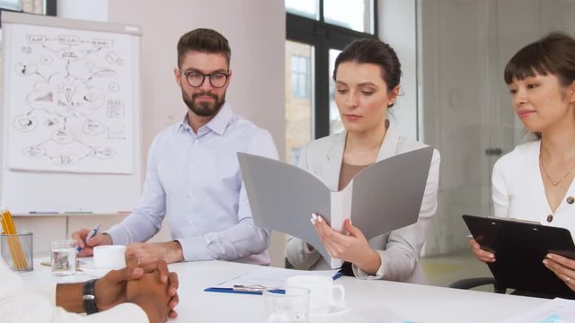 job, hiring and employment concept - international team of recruiters having interview with male employee at office