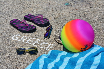 Fototapeta na wymiar The word Greece made of shells on beach in the sand.