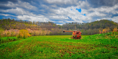 Obraz premium Old Abandoned Harvester in a Field