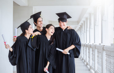 Young asian man woman graduated holding certificate standing in line in front of university...