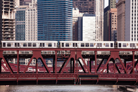 Trains running over the metal bridge in Chicago