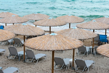Beach umbrellas woven from cane on a sandy beach