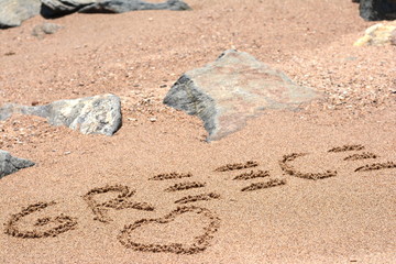 The word Greece written in the sand on beach