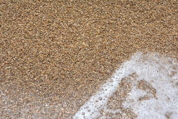 Beautiful soft waves of Blue Ocean with Sandy Beach Background close up. Sea sand wallpaper