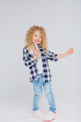 baby girl with microphone smiling singing,Fat girl singing song into microphone. Young star, looking for talents