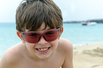 boy in sunglasses on the beach