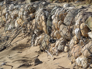 protection of the shore from the waves with stones.
