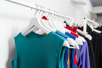 Obraz premium Cocktail dress. Clothing on hanger at the modern shop boutique. Bright multi-colored fabrics. concept of shopping.