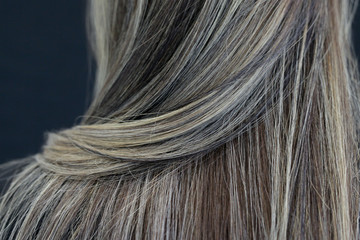 Naklejka premium Beauty and hairstyle. Close up portrait of Brown voluminous hair of lady. Hair Coloring
