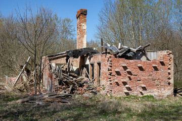 An old demolished little house in the middle of the forest. Household ruins in Central Europe.