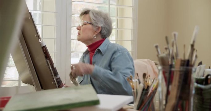 Elderly Retirement Female Painting in Home