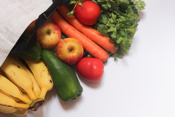 Eco natural bags, Grocery food shopping bag with fruits and vegetables. Concept plastic free items. reuse, reduce, recycle, refuse, sustainability. Copy space in white background.