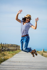 Young indian woman jumping in the countryside