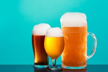 Golden beer in glass with foam, alcohol beverage,  lager drop.