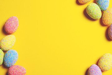 Colorful easter eggs on yellow background.
