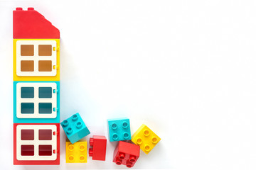 House of Small and big plastic constructor bricks on white background. Popular toys.