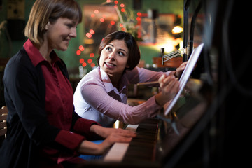 young woman having a piano class