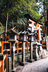 Orange gates and objects at Fushimi Inari-Taisha Shrine in Kyoto, Japan