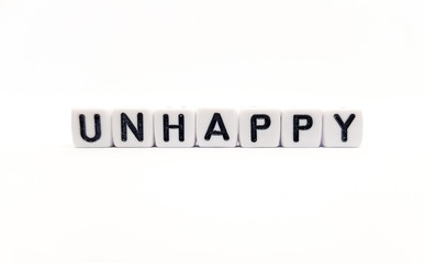 unhappy word built with white cubes and black letters on white background