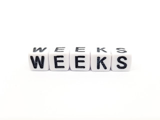 weeks word built with white cubes and black letters on white background