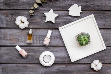 perfume, nail polish, concrete figures and tray decorations for morden home office on wooden background flat lay