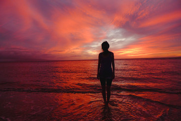 Fototapeta na wymiar Hawaii Sunset Silhouette with girl