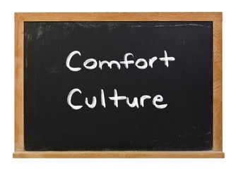 Obraz premium Comfort culture written in white chalk on a black chalkboard isolated on white