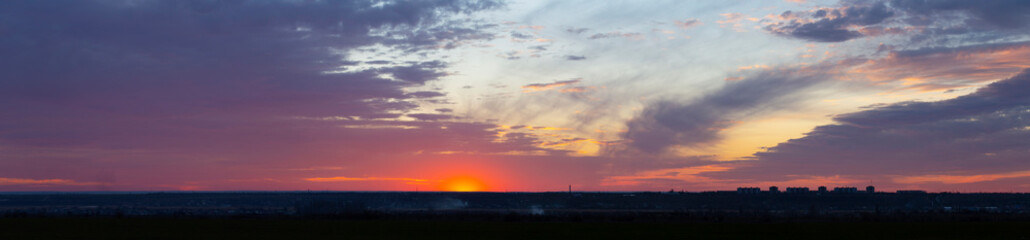 Landscape with bloody sunset. The terrain in southern Europe. Tragic gloomy sky. Purple-magenta clouds.