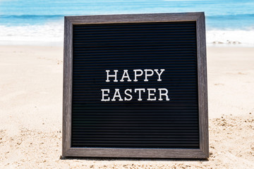 Happy Easter beach background with black board