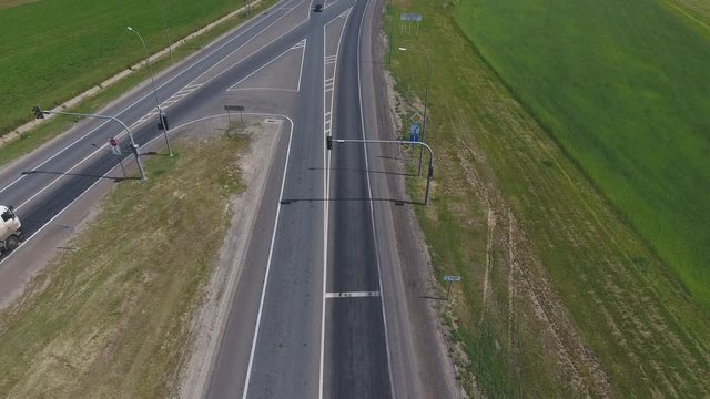 Transport interchange. The movement of cars on the road. Top view of the road and cars. Summer video from the drone. Rural landscape.