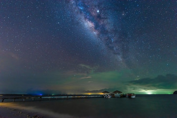 The Milky Way is above the bridge that stretches out into the sea, Koh Mak, Trat, Thailand