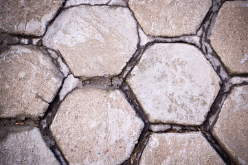 hexagon shaped tile paved sidewalk with vignette. background, urban.
