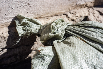 Old green cloth bag near the building