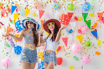 celebration new year or birthday party group of asian young woman and confetti happy,funny concept.drinking wine happy and fun in new year celebrate, color balloon  background.