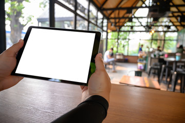 businessman hand working on tablet on wooden desk tablet with blank screen mockup Digital tablet computer